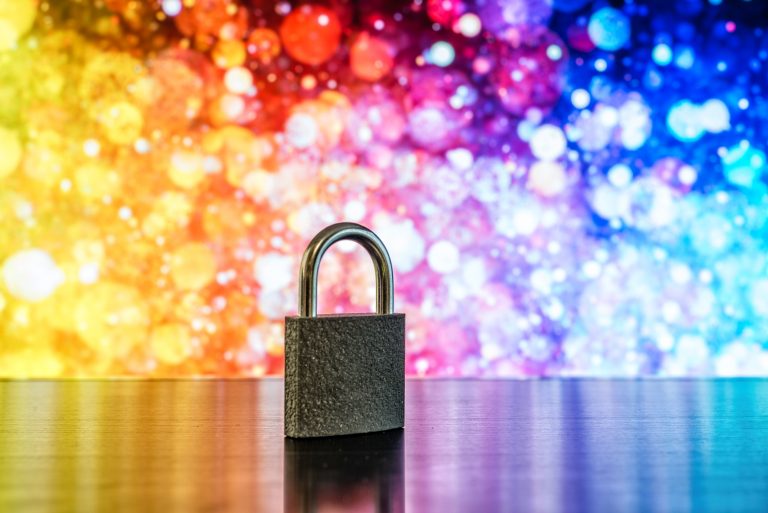 Padlock against bright abstract background.