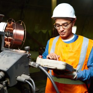 Engineer operating factory equipment.