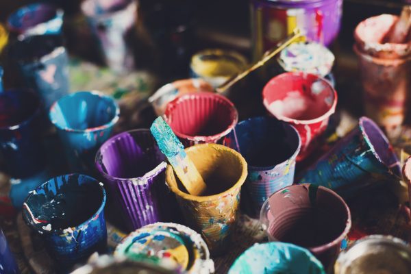Multicoloured used paint pots.