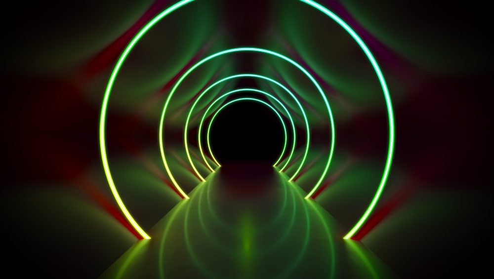 Tunnel lit by circular green neon lights.