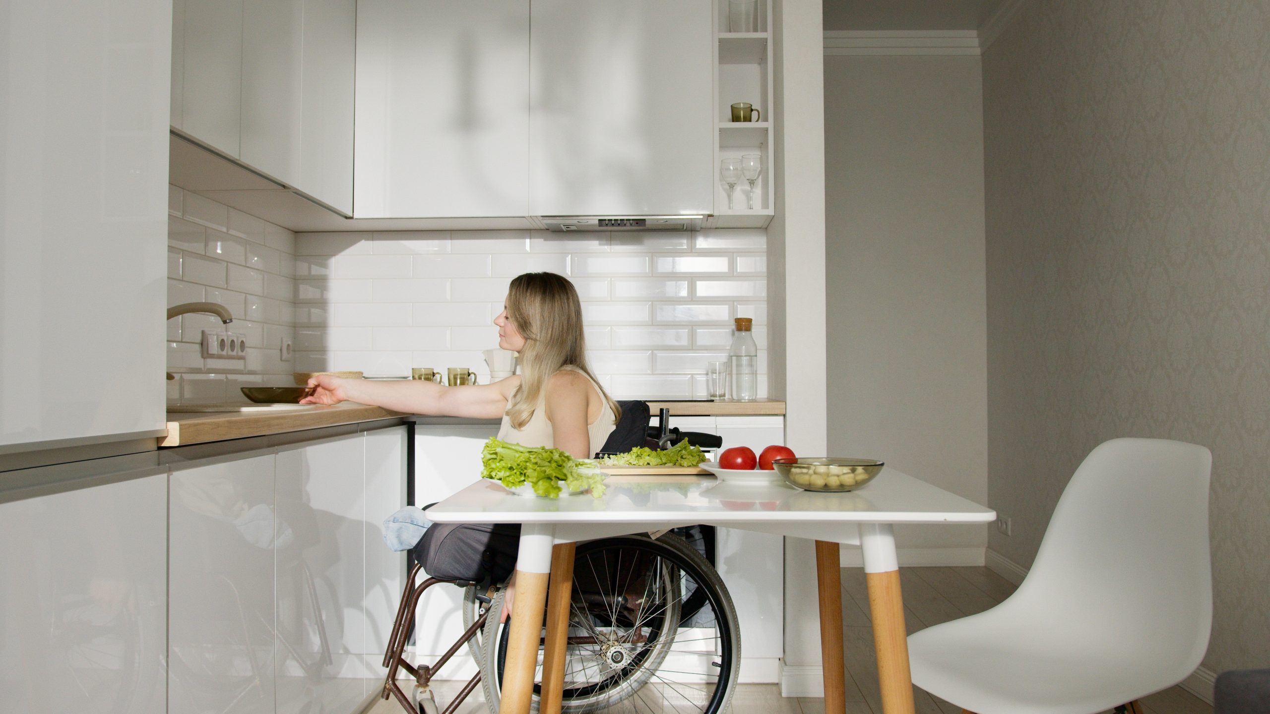 person in wheelchair in a kitchen