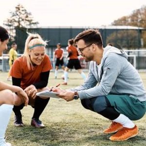 Sports coach talking to players