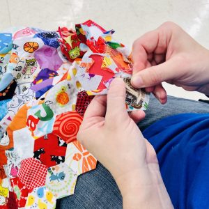 Person sewing patchwork.
