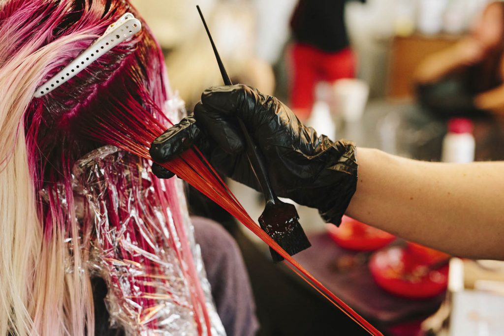 Close up of hair being coloured in salon.