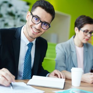 Smile business man working with paperwork.