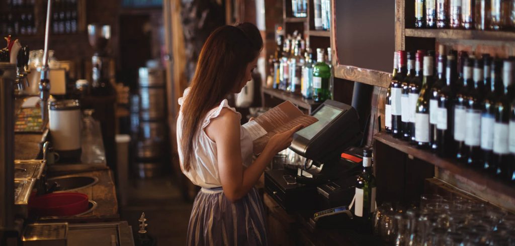 Bar person looking at the menu