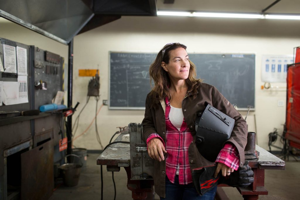 Welding teacher in workshop.