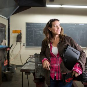 Welding teacher in workshop.