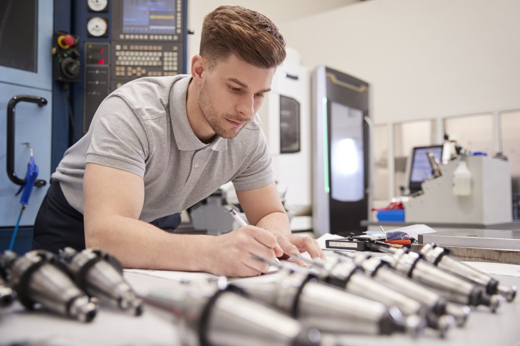 Man checking drawing in factory.