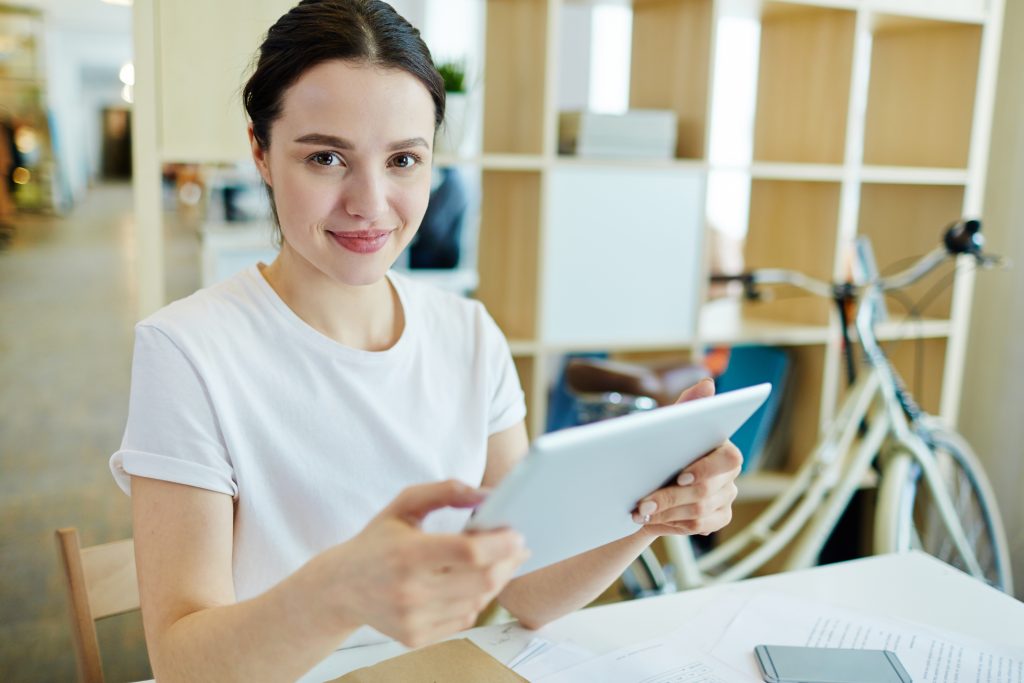 Woman working on digital tablet.