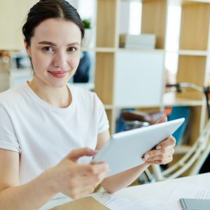 Woman working on digital tablet.