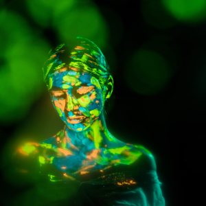 Person painted with bright neon paints