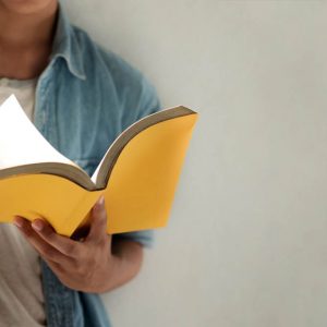 Cropped image of person reading a book.