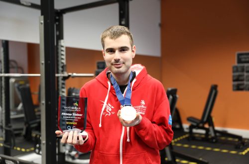 Kyle holding medal and trophy.