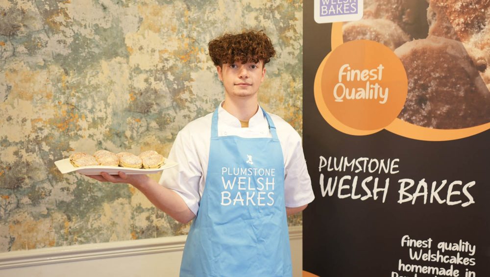 Tom Wickens holding plate of Welsh cakes.