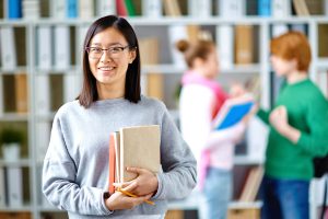 LEarners holding books in library