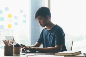 Person working on laptop at desk