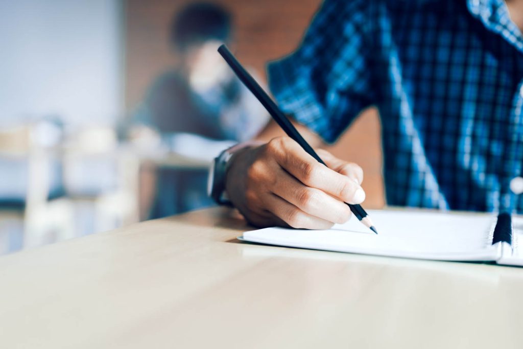hand holding a pencil writing