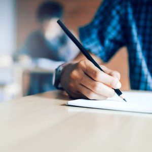 hand holding a pencil writing