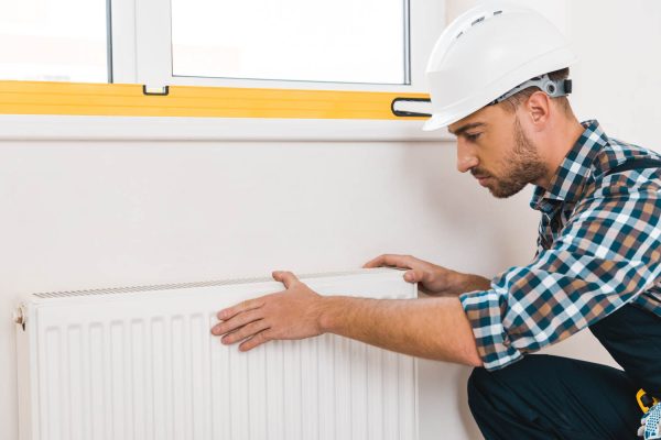 Plumber installing Radiator