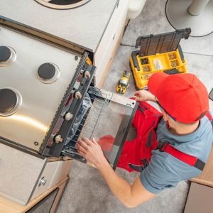 Workman fixing gas oven