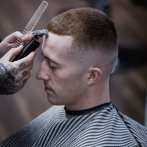 Person having hair trimmed with clippers