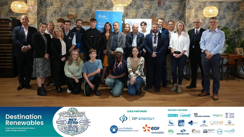 large group of learners and staff with banner at bottom containing logos and text: Destination Renewables