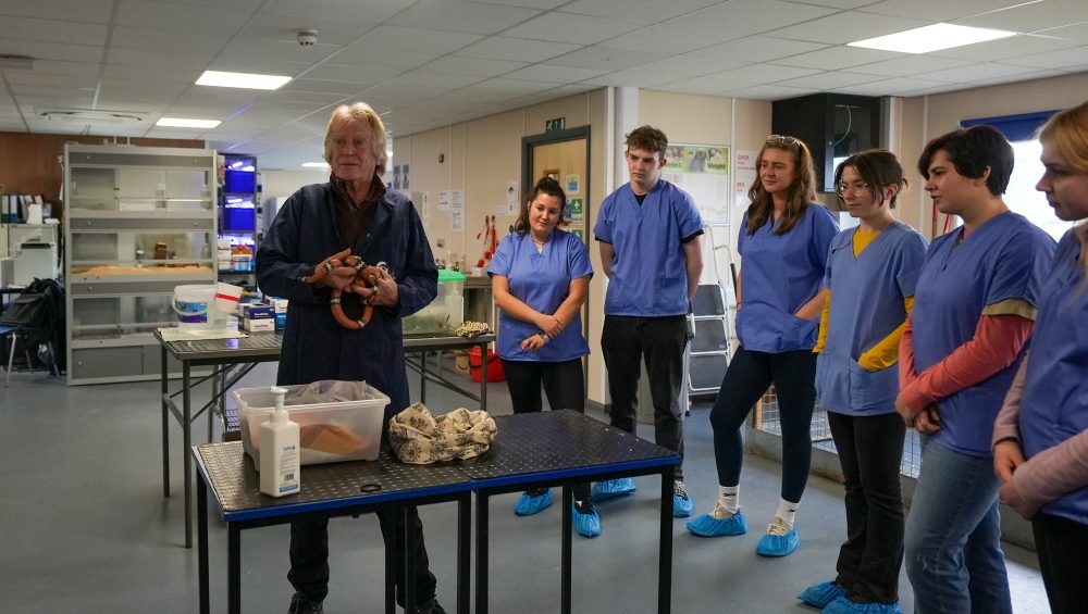 Lecturer talking to students in animal workshop.