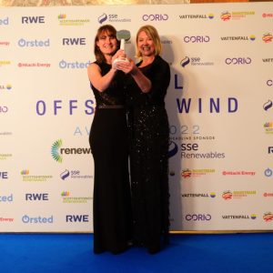 Two staff members holding award.