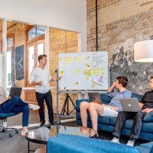 people meeting looking at a white board
