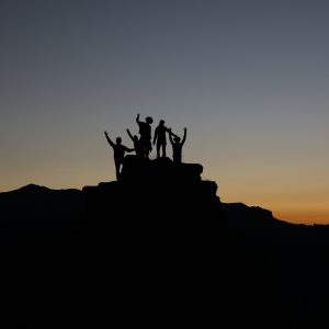 silhouette of people on mountain top