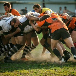 Group of rugby players in a tackle