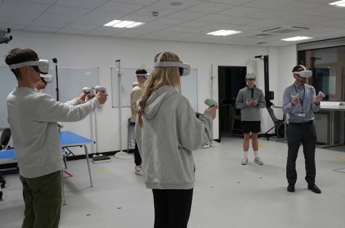 Students wearing virtual reality gear on Swansea University trip