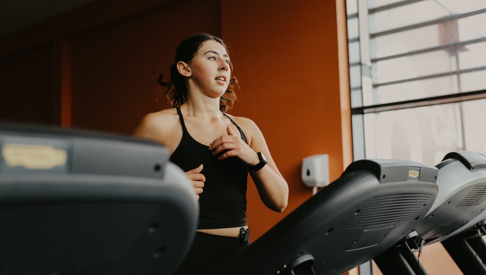 A woman running on treadmill in gym