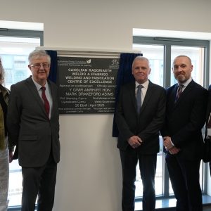 First Minister Mark Drakeford with Pembrokeshire College Principal Barry, Nick Revell, Iwan Thomas and Engineering learner Rhiannon stood beside the Welding and Fabrication Centre of Excellence Plaque