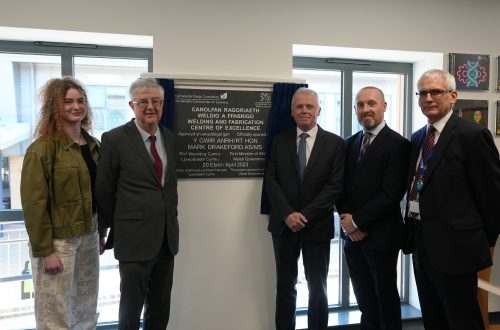 First Minister Mark Drakeford with Pembrokeshire College Principal Barry, Nick Revell, Iwan Thomas and Engineering learner Rhiannon stood beside the Welding and Fabrication Centre of Excellence Plaque