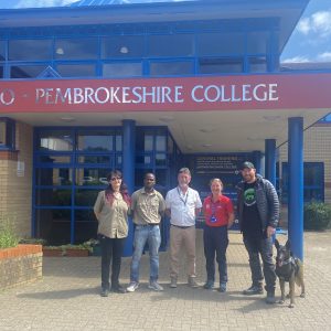 Dogs 4 Wildlife team with Pembrokeshire College Animal Care Tutors outside the College building.