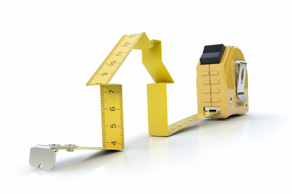 A protruding Tape Measure rule moulded into a house image.