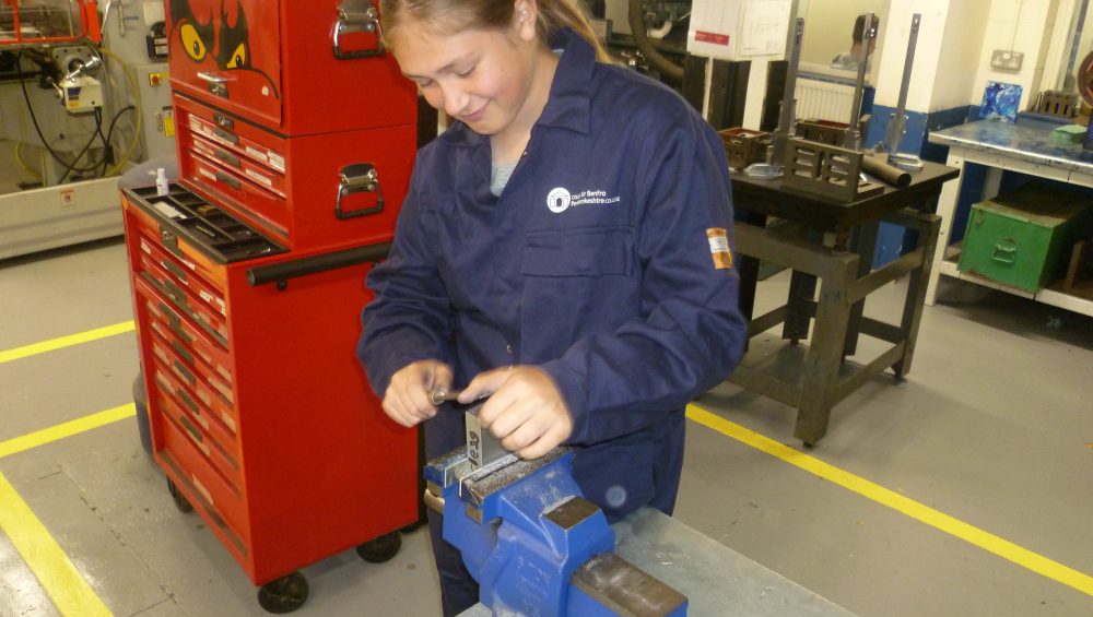 Student Emma working in engineering workshop.