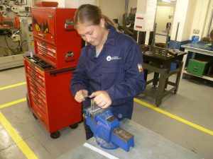 Student Emma working in engineering workshop.