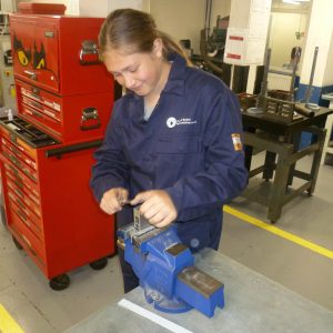 Student Emma working in engineering workshop.