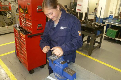 Student Emma working in engineering workshop.
