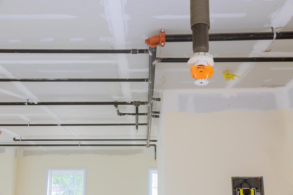 Automatic fire sprinkler system install on pipe ceiling background in building