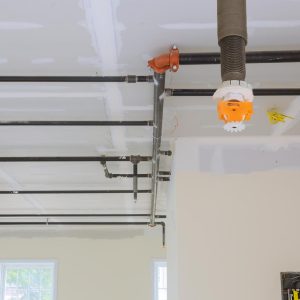 Automatic fire sprinkler system install on pipe ceiling background in building