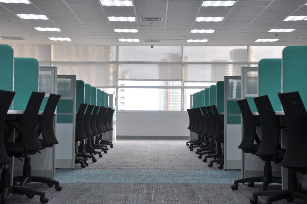 rows of desk cubicles in office
