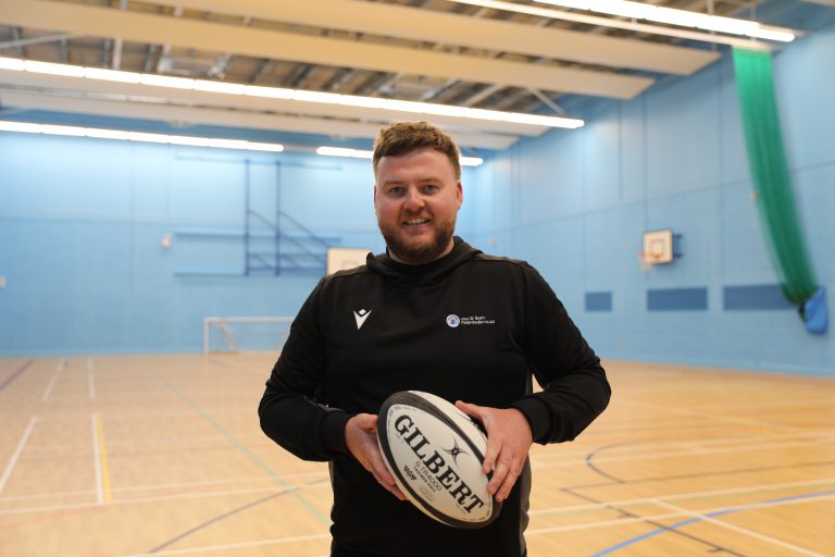 WRU Rugby Officer, Aled holding a rugby ball