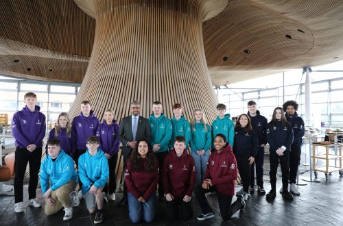 Competitors in the Senedd wearing hoodies and Vaughan Gething is centre