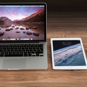 A laptop, iPad and phone on a table