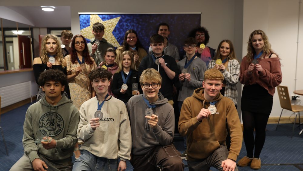 Group of learners holding medals