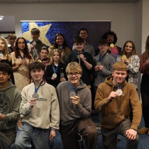 Group of learners holding medals